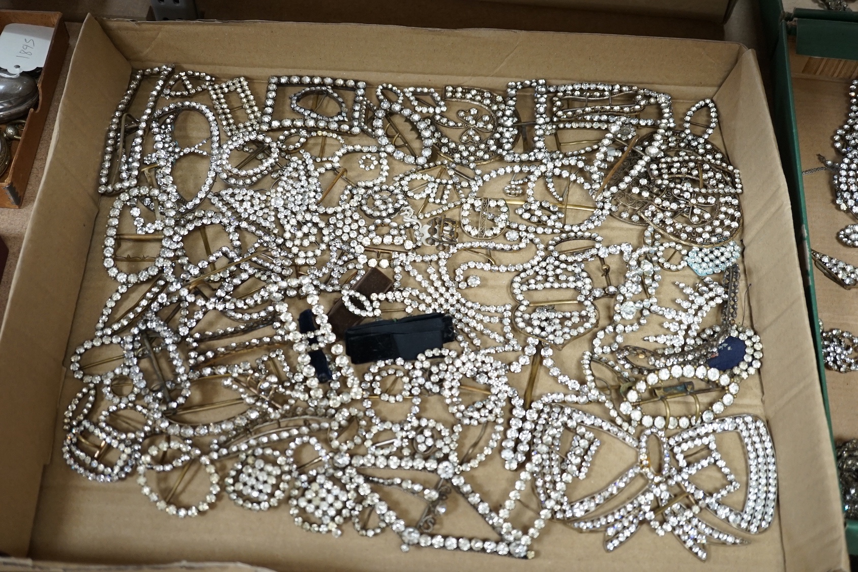 A large quantity of assorted white paste set buckles and brooches.